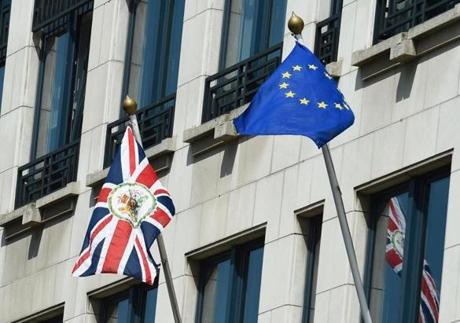 A photo taken on June 24, 2016 shows the United Kingdom flag and European flag in front of the UK representative to the EU in Brussels. European Commission chief Jean-Claude Juncker said Britain's planned departure from the European Union was 
