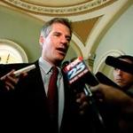 Scott Brown talks with members of the news media on Capitol Hill in Washington, DC.