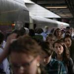 Commuters walked along a crowded South Station platform. The proposed South Coast rail line to New Bedford and Fall River would terminate there.