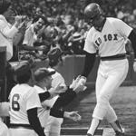 Carlton Fisk is congratulated at the dugout by manager Don Zimmer after hitting a three-run home run against the Yankees at Fenway Park on Sept. 20,1977.