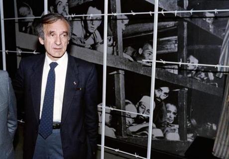 Nobel laureate and writer Elie Wiesel stood in front of a photo of himself and other inmates that was taken at Buchenwald in 1945.
