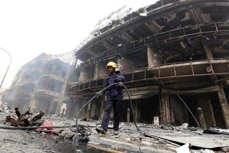 An Iraqi firefighter works at the site of a suicide car bombing claimed by the Islamic State group on July 3, 2016 in Baghdad's central Karrada district. The blast, which ripped through a street in the Karrada area where many people go to shop ahead of the holiday marking the end of the Muslim fasting month of Ramadan, killed at least 75 people and also wounded more than 130 people, security and medical officials said. The Islamic State group issued a statement claiming the suicide car bombing, saying it was carried out by an Iraqi as part of the group's 