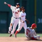 Second baseman Dustin Pedroia makes a catch too late to tag out Andrelton Simmons in the sixth inning.