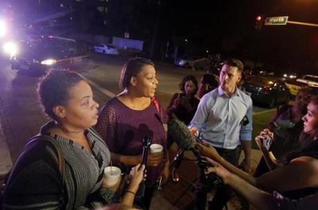 Sherry Williams, left, and Theresa Williams, center, speak to the media as they leave the Baylor University Medical Center, Friday, July 8, 2016, in Dallas. Theresa Williams said her sister Shetamia Taylor, who was attending a rally with her four teenage sons in downtown Dallas, was shot in one of her legs. (AP Photo/Tony Gutierrez)
