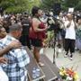 Valire Castile, center, addresses hundreds at the JJ Hill Montessori School where her son Philando worked Thursday, July 7, 2016, in St. Paul, Minn. where a vigil was held following the shooting death by police of Philando Castile Wednesday night in Falcon Heights, Minn. after a traffic stop by St. Anthony police. (AP Photo/Jim Mone)