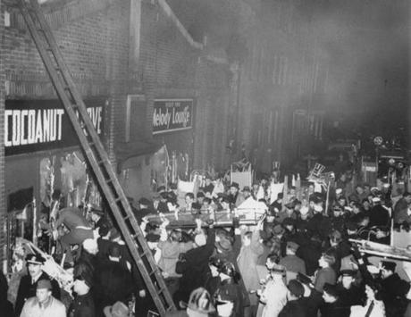 Police, firefighters and volunteers removed bodies at the rear entrance to Cocoanut Grove Night Club after the 1942 fire.
