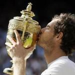 Andy Murray of Britain kisses his trophy after beating Milos Raonic of Canada in the men's singles final on day fourteen of the Wimbledon Tennis Championships in London, Sunday, July 10, 2016. (AP Photo/Kirsty Wigglesworth)