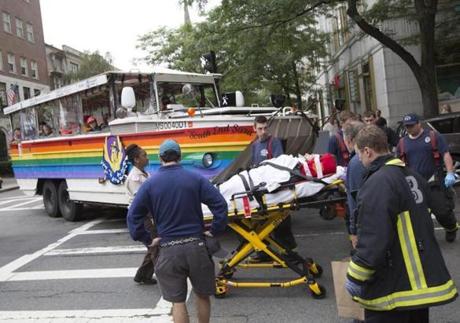 Boston, MA - 07/10/2016 - A woman is taken to a waiting ambulance after being struck by a duck boat in the intersection at Newbury Street and Clarendon Street in Boston, MA, July 10, 2016. (Keith Bedford/Globe Staff) 
