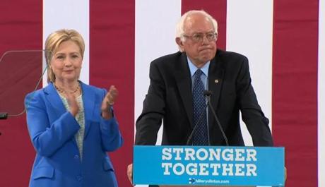 Hillary Clinton (left) and Bernie Sanders took the stage Tuesday at a joint New Hampshire campaign event. 
