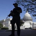 A US Capitol Police officer held a firearm while patrolling outside the Capitol Building while it was on lockdown earlier this month. 