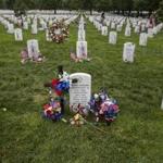 Flowers adorn the gravestone of Marine Lance Cpl. Terry Edward Honeycutt, who died in 2010 from injuries sustained in Afghanistan, on Memorial Day in Section 60 of Arlington National Cemetery in Virginia, May 30, 2016. (Zach Gibson/The New York Times)