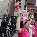 Members of the activist group Code Pink protested in front of Cleveland police officers near the site of the Republican National Convention on Sunday in Cleveland.