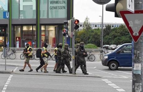 Special police forces approached the scene of a shooting at a shopping centre in Munich.

