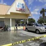 Firefighters hosed down the pavement at the scene of a deadly shooting of a Fort Myers, Fla., nightclub Monday.