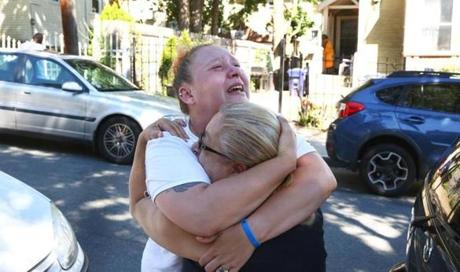 Boston, MA--7/27/2016--The boy's mother Melissa Willis is embraced by neighbor and family friend Aleida Nunez (cq). The family of 7-year-old Kyzr Willis mourns outside their home in Dorchester, on Wednesday, July 27, 2016. It was reported that he was found drowned off Carson Beach on Tuesday. Photo by Pat Greenhouse/Globe Staff Topic: 28kyzr Reporter: Evan Allen
