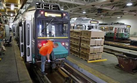 In this June 17, 2015 file photo light rail repairer Kevin Murphy worked on a railcar at the MBTA?s Riverside maintenance facility in Newton.
