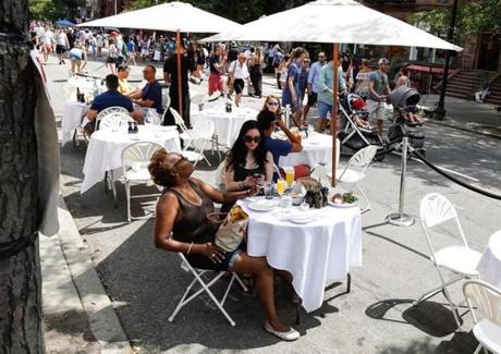 Diners ate at a street cafe set up by Papa Razzi in the middle of Newbury Street on Sunday.
