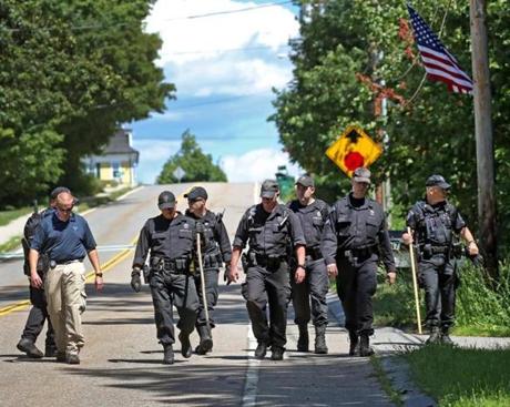 PRINCETON, MA - 8/08/2016:State Police walk down Boylston Ave in Princeton after searching through the woods near the murder scene. Vanessa Marcotte went jogging in Princeton, Mass., and was found dead. The death of a woman in her 20s who went out for a jog in the Central Massachusetts town of Princeton on Sunday is considered suspicious, a law enforcement official said Monday. (David L Ryan/Globe Staff Photo) SECTION: METRO TOPIC 09princeton(2)
