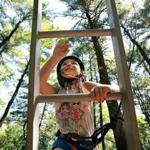 Elizabeth Curran, 6, climbed a ladder on a ropes course at the YMCA?s Camp Ponkapoag in Canton.
