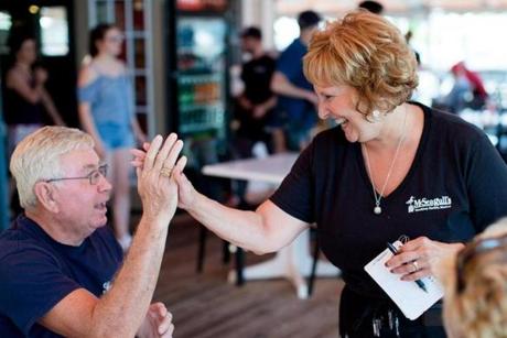 Ann LePage, Maine's first lady, gave a high five to customer John Libby of Phippsburg, Maine.
