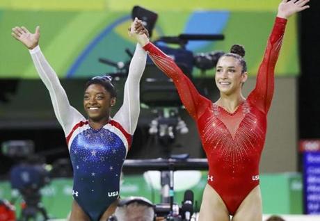 2016 Rio Olympics - Artistic Gymnastics - Final - Women's Individual All-Around Final - Rio Olympic Arena - Rio de Janeiro, Brazil - 11/08/2016. Simone Biles (USA) of USA (L) and Alexandra Raisman (USA) of USA (Aly Raisman) celebrate winning gold and silver respectively at the women's individual all-around final. REUTERS/Mike Blake TPX IMAGES OF THE DAY. FOR EDITORIAL USE ONLY. NOT FOR SALE FOR MARKETING OR ADVERTISING CAMPAIGNS.
