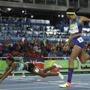 Bahamas' Shaunae Miller falls over the finish line to win gold ahead of United States' Allyson Felix, right, in the women's 400-meter final during the athletics competitions of the 2016 Summer Olympics at the Olympic stadium in Rio de Janeiro, Brazil, Monday, Aug. 15, 2016. (AP Photo/Matt Slocum)