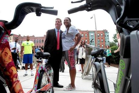 Mayor Martin Walsh and Michelle Cook, founder of Roxbury Rides, celebrated the new Hubway station outside the Roxbury YMCA.
