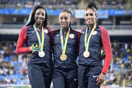 Gold medallist USA's Brianna Rollins (C) poses with silver medallist USA's Nia Ali (L) and bronze medallist USA's Kristi Castlin on the podium of the Women's 100m Hurdles during the athletics event at the Rio 2016 Olympic Games at the Olympic Stadium in Rio de Janeiro on August 18, 2016. / AFP PHOTO / Damien MEYERDAMIEN MEYER/AFP/Getty Images
