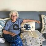 Doris Buffett, in her Back Bay home, with letters she has gotten from people looking to read the aid requests she and her brother, Warren, get and evaluate their merit.