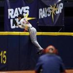 Red Sox left fielder Andrew Benintendi leaped over the left-field wall in the eighth inning in an attempt to make a catch ? one he made successfully.