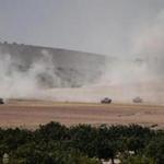 Turkish army tanks and Syrian opposition forces vehicles were stationed near the Turkey-Syria border on Wednesday.