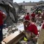 Rescuers pause in Amatrice, central Italy, where a 6.1 earthquake struck just after 3:30 a.m., Wednesday, Aug. 24, 2016. The quake was felt across a broad section of central Italy, including the capital Rome where people in homes in the historic center felt a long swaying followed by aftershocks. (AP Photo/Emilio Fraile)