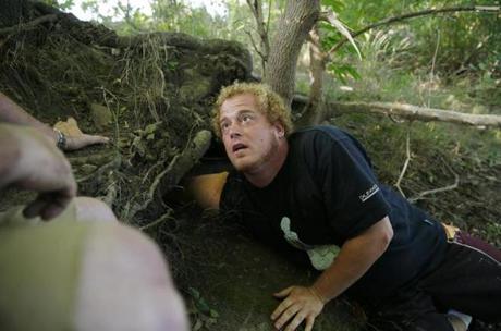 Dominic Kane stuck his arm into a hole as he searched for Wessie the missing python.
