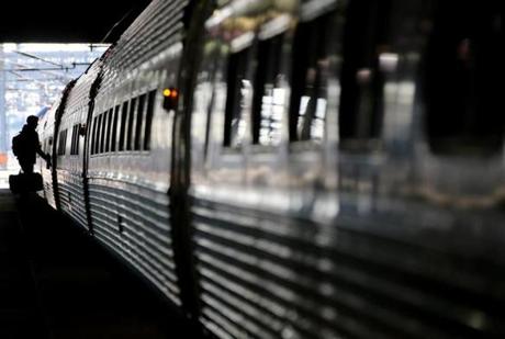 Abington, MA 11/24/2015 â?? A passenger boards an Amtrak train at South Station in Boston, MA on November 24, 2015. The Tuesday before Thanksgiving is considered the busiest travel day of the year in Boston. (Globe staff photo / Craig F. Walker) section: Business reporter:
