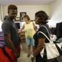 Springfield, MA - 8/12/2016 - Pat ArcandC() smiles with Tomell Kelley(R) and and his grandmother Sophia Weah move into his dorm room at Springfield College in Springfield, MA, August 12, 2016. Five years ago Arcand took Kelley and and fellow student Austin Webster under her wing and shepherded them from a failing Boston middle school through Catholic Memorial. Both are now ready to begin college. (Keith Bedford/Globe Staff) 