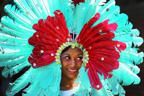Boston-08/27/2016- The annual Caribbean Carnival Parade was held in Dorchester as costumed marchers assembled on Martin Luther King Blvd. The parade with hundreds of marchers and dozens of floats ended at Franklin Park. Natalia Brown with the Royalty group wears aqua feathers in her headdress. Boston Globe staff photo by John Tlumacki(metro)
