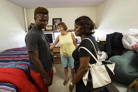 Pat Arcand smiled with Tomell Kelley and his grandmother Sophia Weah as Tomell moved into his dorm room at Springfield College. 
