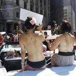 Participants rode in a convertible through midtown Manhattan in the Go Topless Pride Parade on Sunday.