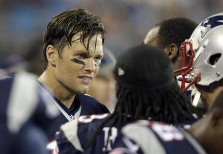 New England Patriots' Tom Brady talks with teammates on the sidelines during the second half of an NFL preseason football game against the Carolina Panthers in Charlotte, N.C., Friday August 26, 2016. New England won 19-17. (AP Photo/Bob Leverone)
