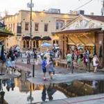 On a rainless June day, water came up through drains to flood the Charleston City Market in Charleston, S.C. Scientists have documented a sharp jump in this nuisance flooding.
