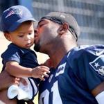 Malcolm Butler with his son during Patriots practice in July.