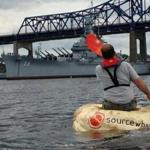 Todd Sandstrum paddled a 1,240-pound pumpkin for 8 miles on the Taunton River, ending at the USS Massachusetts in Battleship Cove in Fall River.