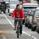 A cyclist makes his way down Route 114 in Salem. 