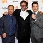 Director Ben Younger poses with actors Miles Teller (R) and Aaron Eckhart (L) as they arrive on the red carpet for the film 