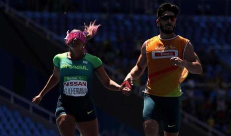 Terezinha Guilhermina of Brazil competes with her guide Rafael Lazarini in the men?s 400m T54 heat two at Olympic Stadium during day five of the Rio 2016 Paralympic Games on Sept. 12. 
