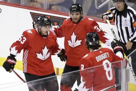 Team Canada's Patrice Bergeron (37) celebrates his goal with Brad Marchand (63) and Drew Doughty (8) during the first period of a World Cup of Hockey exhibition game against Team Russia in Pittsburgh on Wednesday, Sept. 14, 2016. (AP Photo/Gene J. Puskar)
