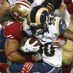 Los Angeles Rams running back Todd Gurley (30) is tackled by San Francisco 49ers nose tackle Mike Purcell (64) and safety Eric Reid (35) during the first half of an NFL football game in Santa Clara, Calif., Monday, Sept. 12, 2016. (AP Photo/Tony Avelar)