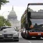 A bus drove by an Audi self-driving vehicle parked on Pennsylvania Avenue near the Capitol in Washington.