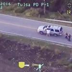epa05549232 A frame grab from video released by the Tulsa, Oklahoma, USA, Police Department and acquired on 20 September 2016 reportedly shows Terrence Crutcher (R) walking with his hands in the air as he is confronted by police after his automobile broke down in Tulsa, Oklahoma, USA, on 16 September 2016. Crutcher then walked back to his vehicle where he was shot by an officer. He died after being taken to a hospital later that night. No weapon was found either on Crutcher or in his vehicle. EPA/TULSA POLICE DEPARTMENT / HANDOUT HANDOUT EDITORIAL USE ONLY/NO SALES