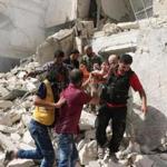 Rescuers remove a victim Wednesday from the rubble of a building after a reported air strike in Aleppo.
